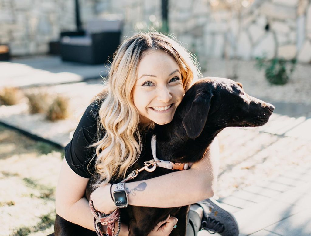 women hugging dog