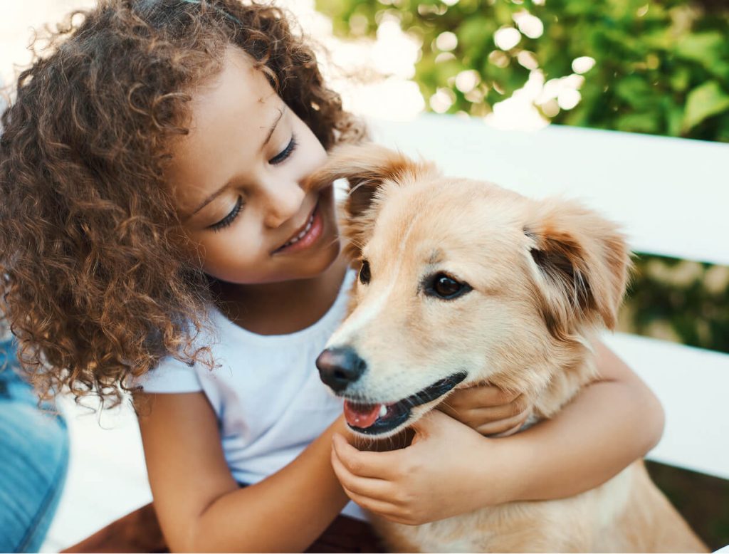 kid holding dog